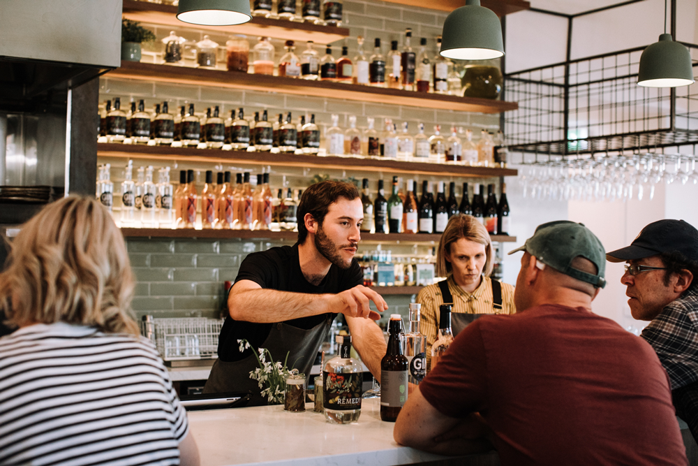 Reed & Co barman talking to customers