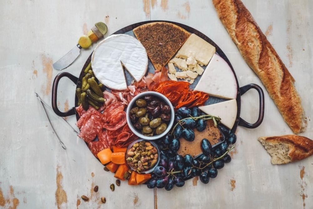 Cheese board with meats, seafood, olives and nuts 
